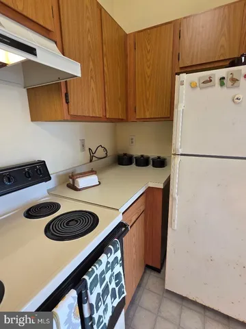 a kitchen with a refrigerator and a stove