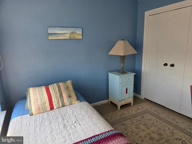 a bedroom with a bed and a lamp on table