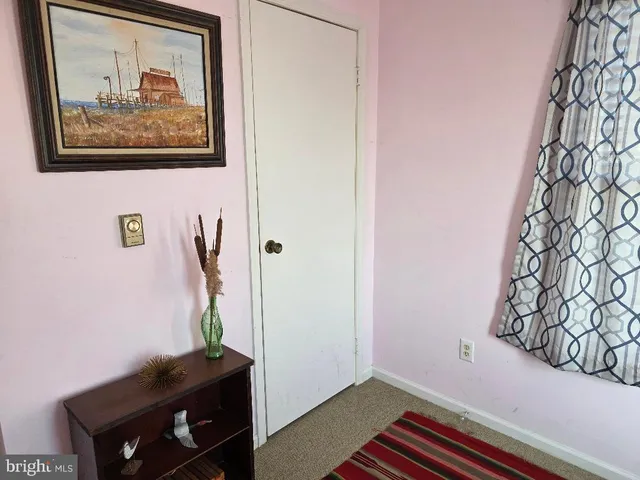 a room with a wall and a painting on the wall