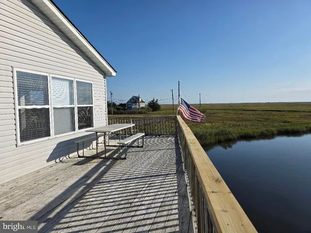 a view of wooden deck with a lake view