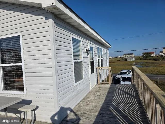 a view of a balcony with chairs and wooden floor