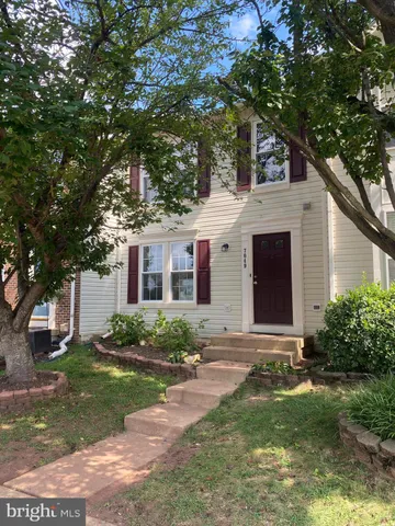 a front view of a house with a yard and a garage