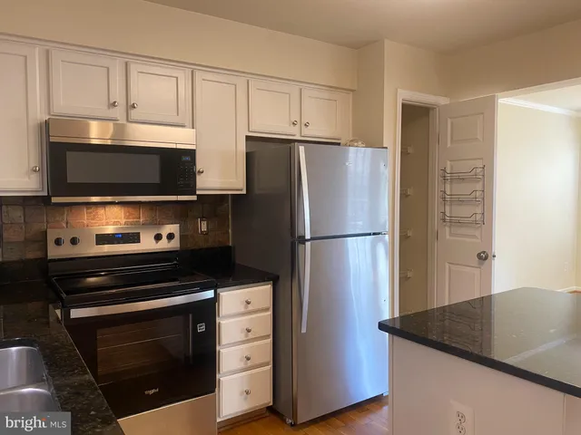 a view of a workspace with furniture and window