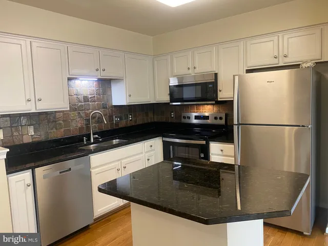 a view of entryway with wooden floor and stairs