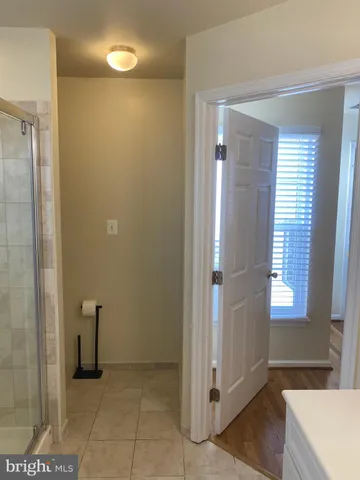 an empty room with a window and wooden floor