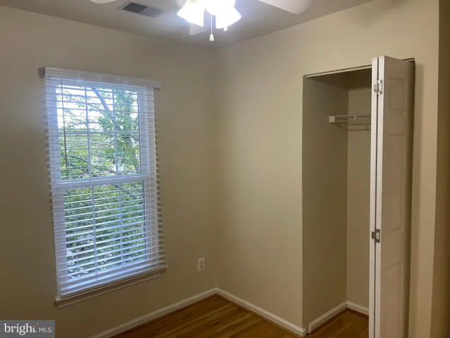 a view of a room with wooden floor and natural light