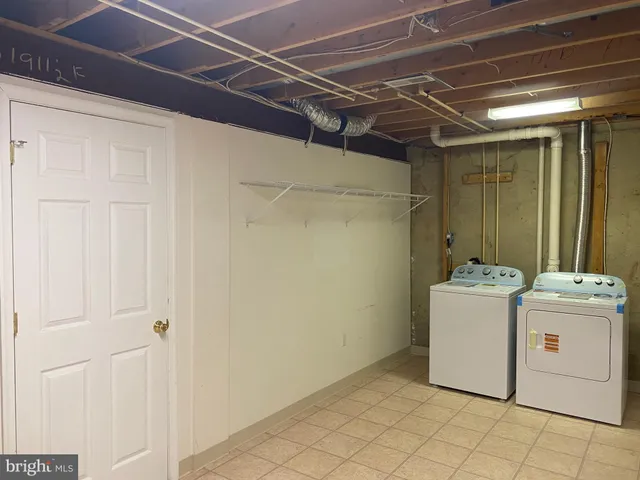 a view of a backyard with a chair and wooden fence