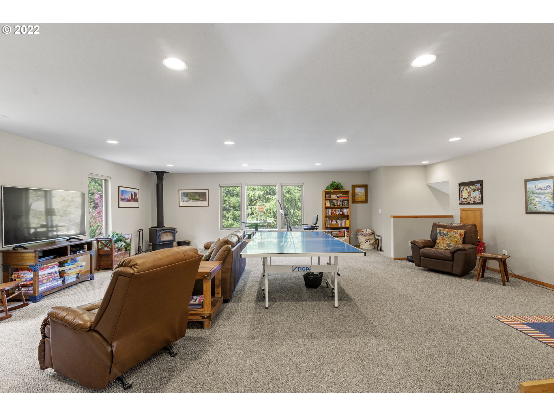 19601 Northeast 42nd Court Ridgefield, WA 98642 - Photo 30 of 32 a living room with furniture and a flat screen tv