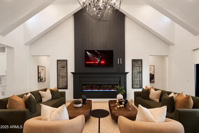 a kitchen with stainless steel appliances kitchen island granite countertop a dining table chairs stove refrigerator and cabinets