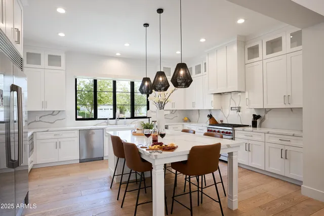 a kitchen with a sink a window and stainless steel appliances