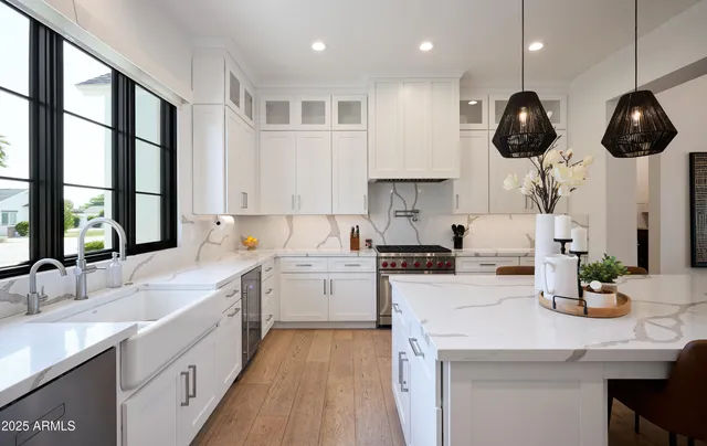 a kitchen with a stove a sink and a window