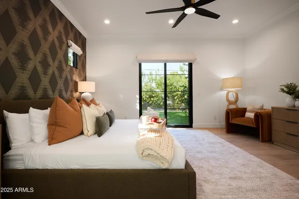 a bedroom with furniture and a flat screen tv