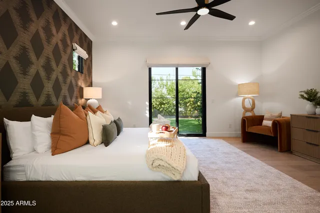 a bedroom with furniture and a flat screen tv