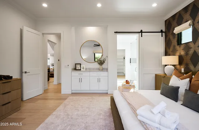 a bedroom with a bed and a painting on the wall