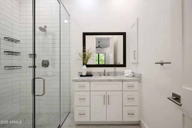 a white bath tub sitting in a bathroom next to a window