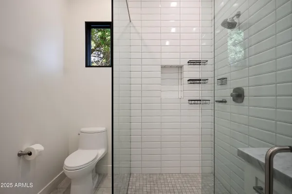 a spacious bathroom with a bathtub and shower