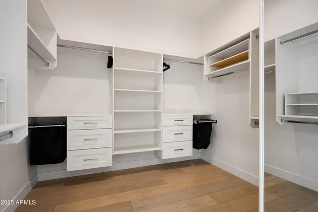 a bedroom with a bed and wall painting