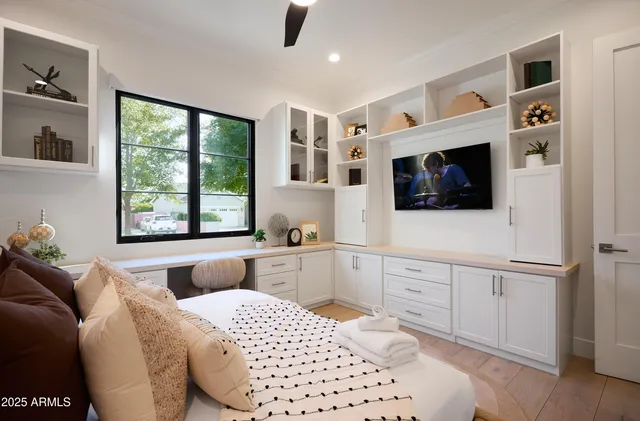 a bathroom with white cabinets sink and mirror