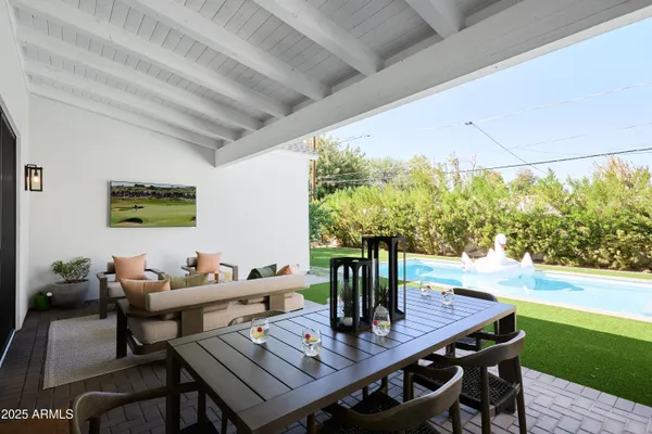 a view of a patio with table and chairs with the garden
