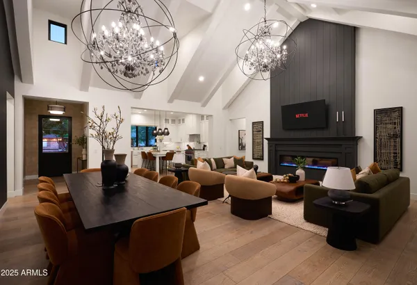 a living room with furniture a large window and a fireplace