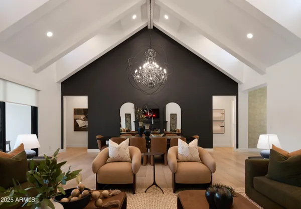 a living room with furniture a large window and a fireplace