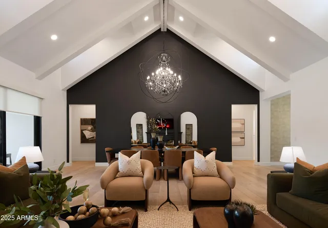 a living room with furniture a large window and a fireplace