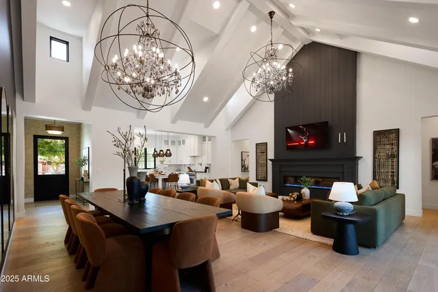 a living room with furniture a fireplace and a chandelier