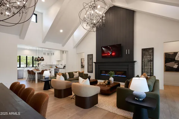 a living room with fireplace furniture and a chandelier