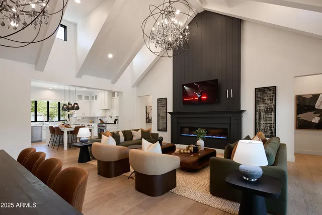 a living room with fireplace furniture and a chandelier