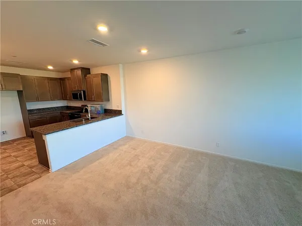 a view of kitchen with kitchen island and wooden floor