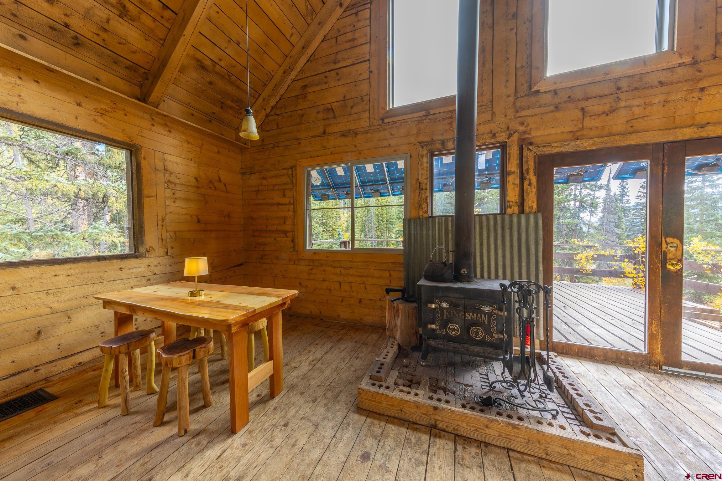 824 County Road Crested Butte, CO 81224 - Photo 9 of 39 a dining room with wooden floor and windows