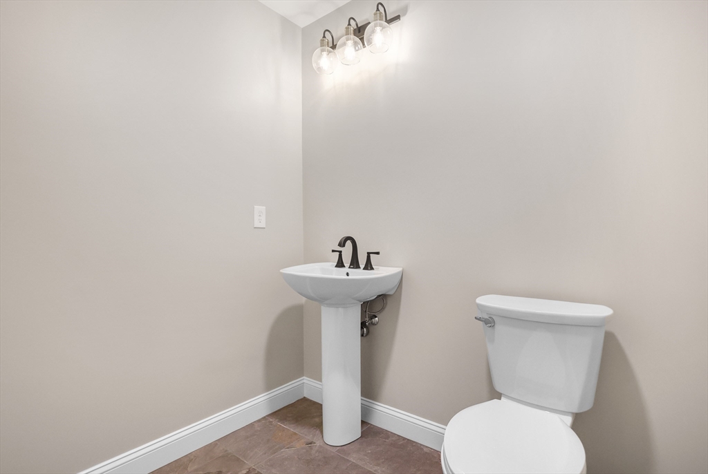 13 Main Street, Unit 13 Newbury, MA 01922 - Photo 16 of 36 a bathroom with a toilet sink and mirror