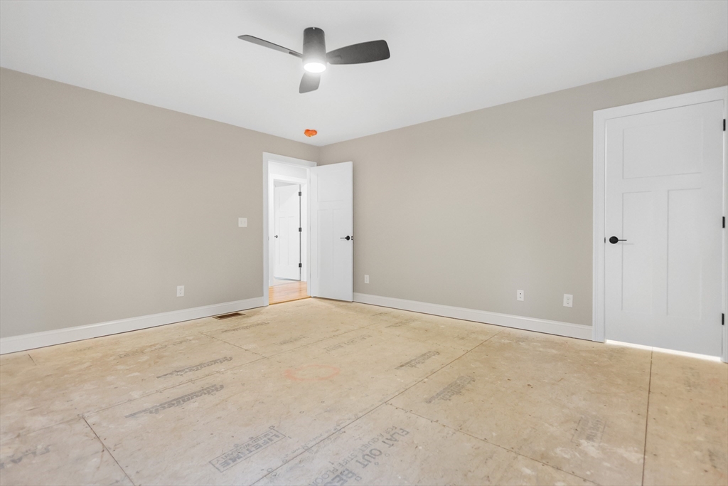 13 Main Street, Unit 13 Newbury, MA 01922 - Photo 24 of 36 an empty room with a ceiling fan and a window