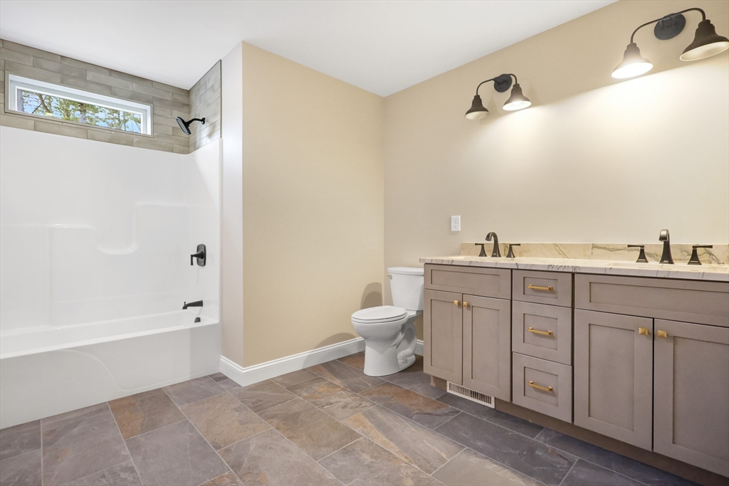 13 Main Street, Unit 13 Newbury, MA 01922 - Photo 25 of 36 a bathroom with a granite countertop sink toilet and shower