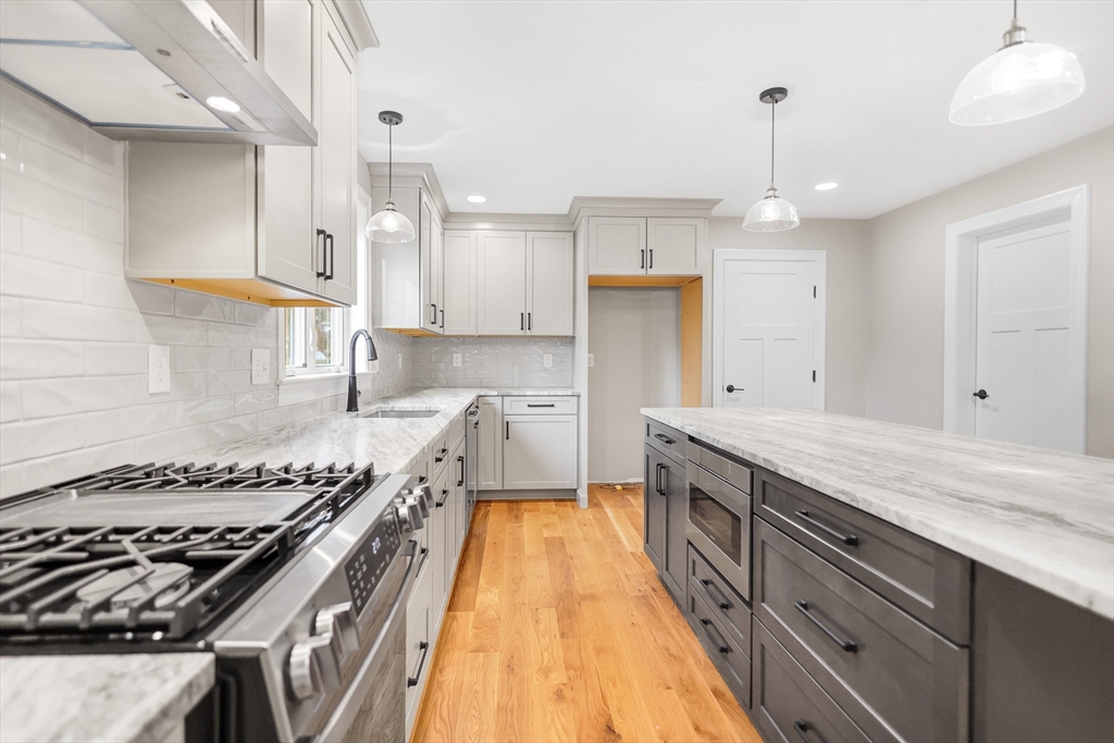13 Main Street, Unit 13 Newbury, MA 01922 - Photo 6 of 36 a kitchen with a stove a sink a refrigerator and window