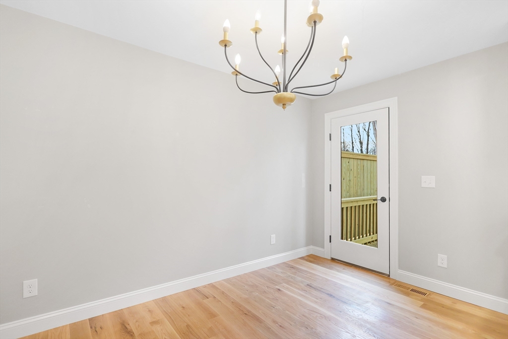 13 Main Street, Unit 13 Newbury, MA 01922 - Photo 10 of 36 a view of empty room with wooden floor and fan