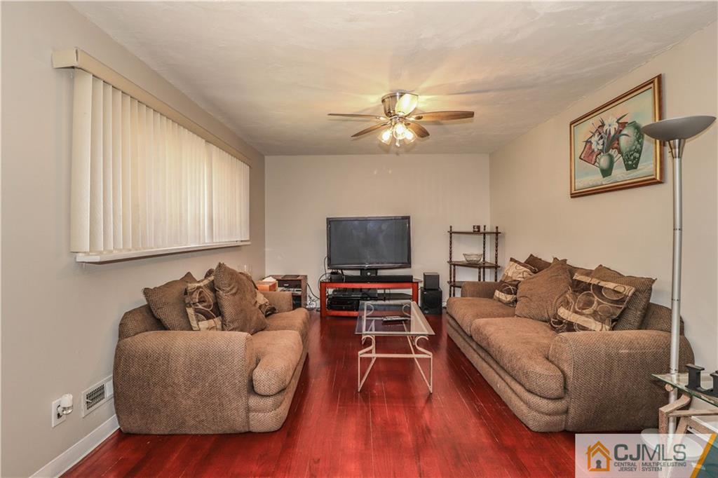 11 Brookside Road Edison, NJ 08817 - Photo 12 of 26 a living room with furniture and a flat screen tv