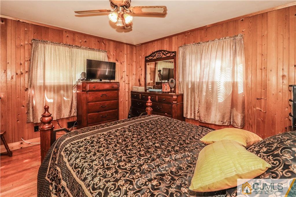 11 Brookside Road Edison, NJ 08817 - Photo 15 of 26 a bedroom with a bed and wooden floor