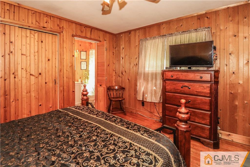 11 Brookside Road Edison, NJ 08817 - Photo 16 of 26 a bedroom with a bed and a flat screen tv