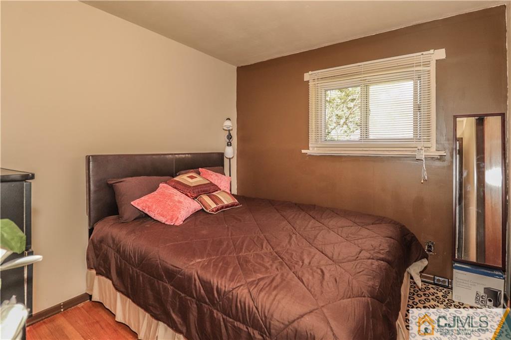 11 Brookside Road Edison, NJ 08817 - Photo 17 of 26 a bedroom with a bed and a window