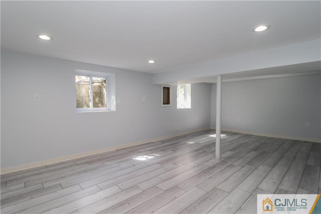 11 Brookside Road Edison, NJ 08817 - Photo 20 of 26 an empty room with wooden floor and windows