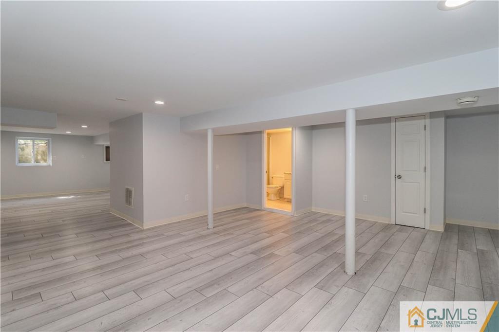 11 Brookside Road Edison, NJ 08817 - Photo 22 of 26 an empty room with wooden floor and windows