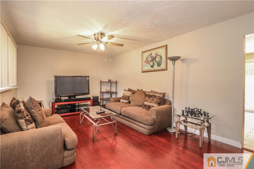 11 Brookside Road Edison, NJ 08817 - Photo 6 of 26 a living room with furniture and a flat screen tv