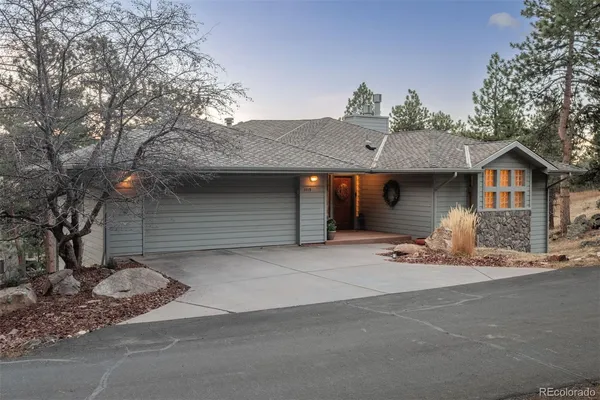 a front view of a house with a tree
