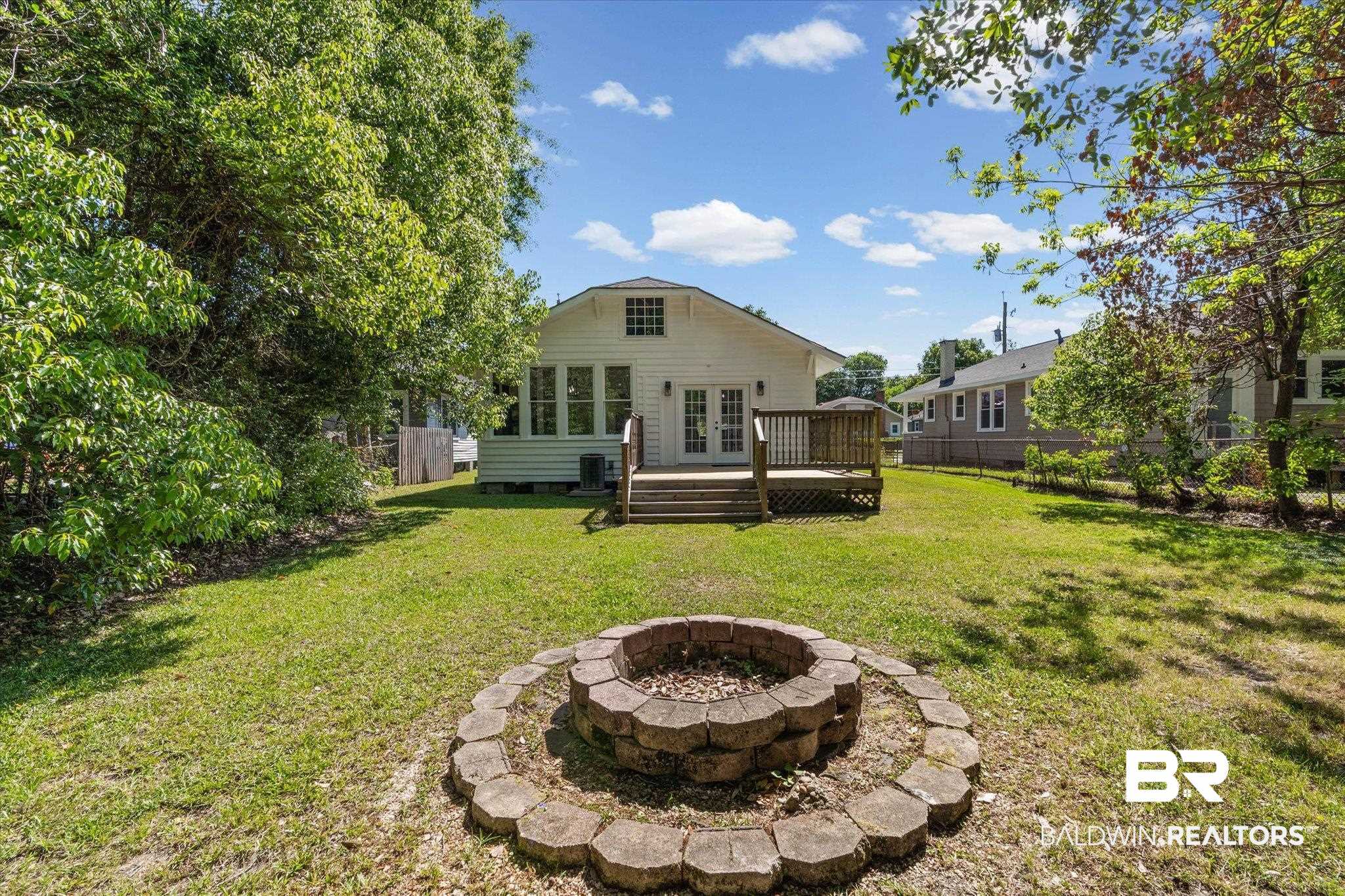 121 North Carlen Street Mobile, AL 36607 - Photo 20 of 21 Rear view of property with a fenced backyard, an outdoor fire pit, a deck, and crawl space
