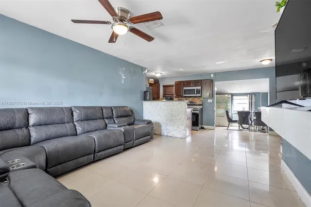 a living room with furniture and kitchen view