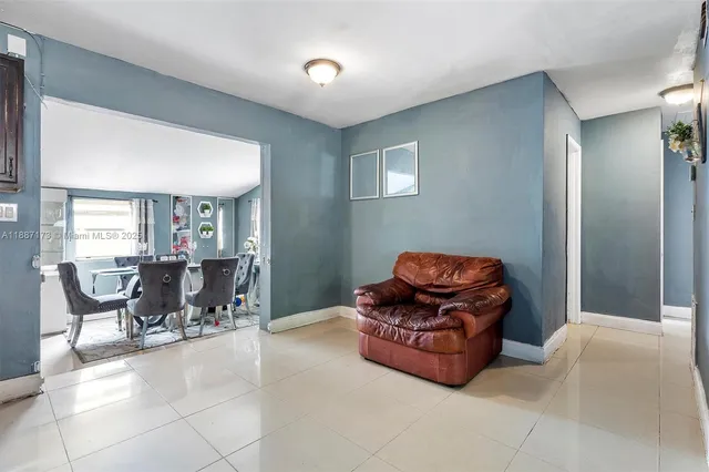 a living room with furniture and a piano