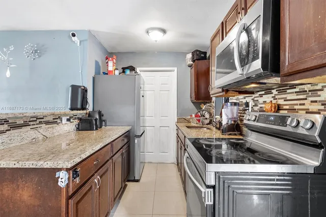 a kitchen with stainless steel appliances granite countertop a stove and a sink