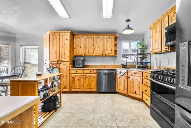 a view of a dining room with furniture and a chandelier