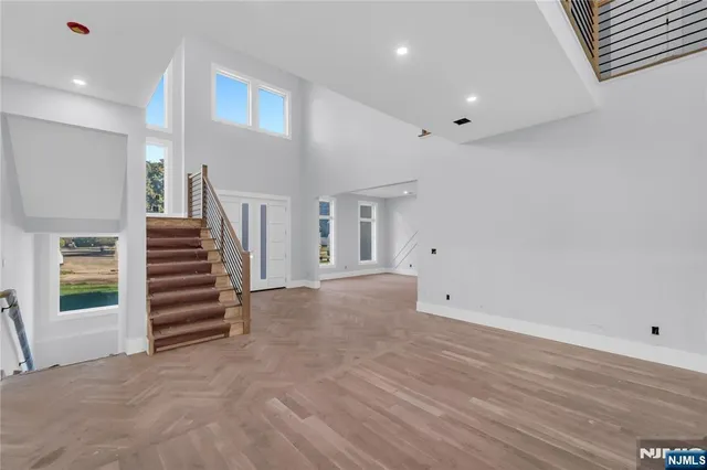 a view of an empty room with stairs and ventilation
